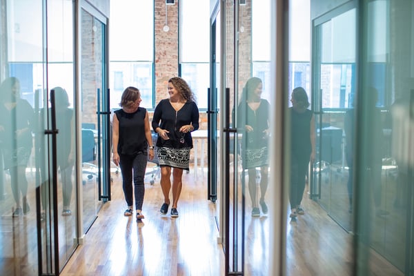 Gather Richmond Co-workers Walking Down Glass Hallway of Offices